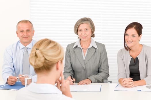 Business interview young woman being examined by professional manager team
