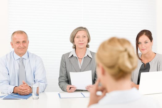 Business interview young woman being examined by professional manager team