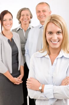 Business team attractive young businesswoman with happy mature colleagues