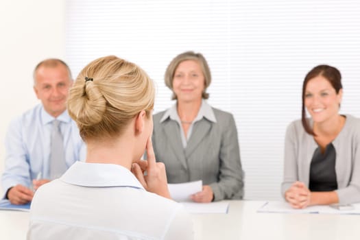 Business interview young woman being examined by professional manager team