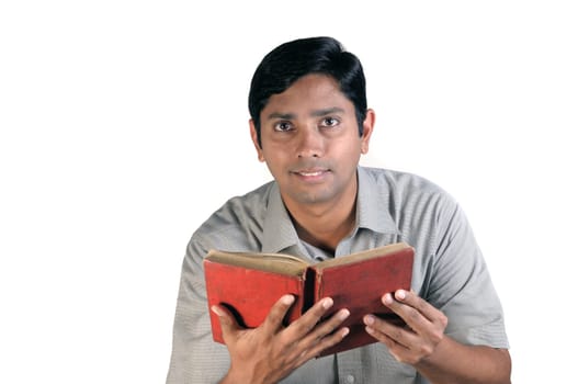 An handsome middle aged man reading an old book
