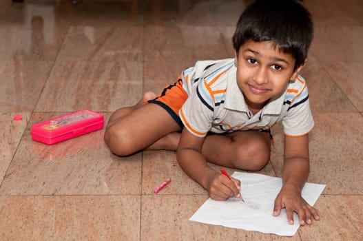 an handsome indian kid doing homework