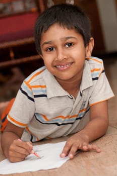 an handsome indian kid doing homework