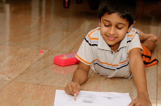 An Handsome Indian boy doing his artwork