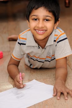 An Handsome Indian boy doing his artwork