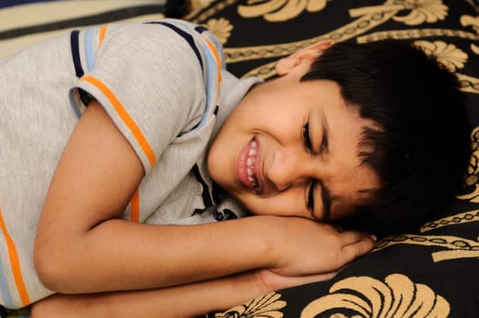 An handsome Indian kid sleeping very happily