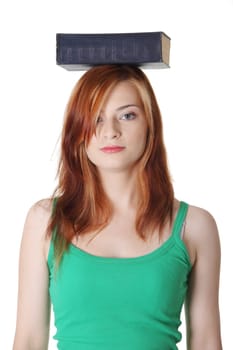 Teen pretty caucasian student holding blue book on her head. Isolated on white.