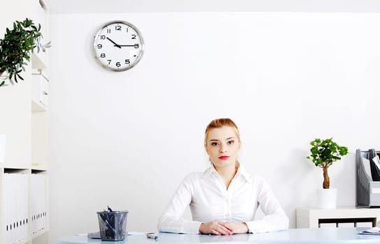 Beautiful woman sitting behind the desk in her office.