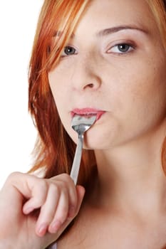 Teen pretty caucasian girl licking tea spoon.