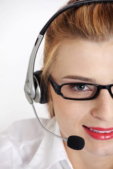 Closeup on pretty woman`s face with headset.