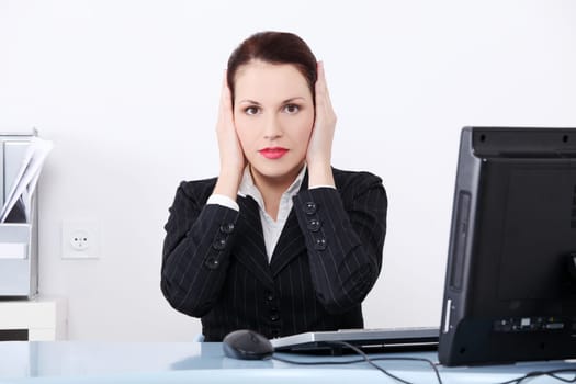 Pretty caucasian businesswoman in the hear no evil pose.