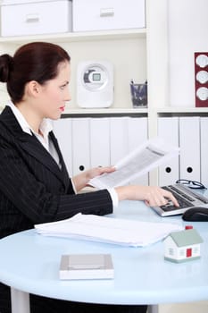 Pretty caucasian businesswoman working on the computer in the office.
