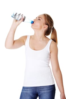 Teen woman drinking mineral water from bottle