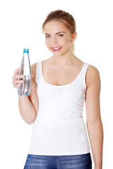 Teen woman drinking mineral water from bottle