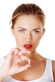 Teen girl holding a capsule pill
