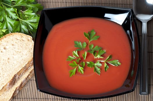closeup of a tomato soup with parsley