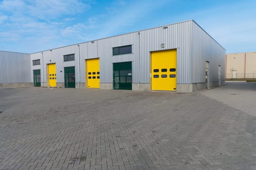 industrial warehouse with green and yellow roller doors