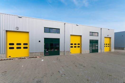 industrial warehouse with green and yellow roller doors