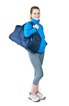 Happy fit young woman with gym bag standing ready for fitness exercise