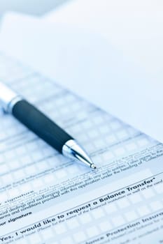 Blank credit application form with envelope and pen close up