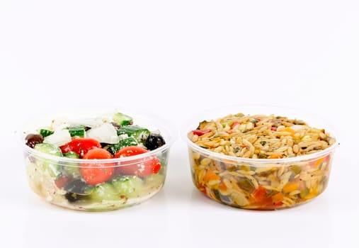 Two servings of prepared salad in plastic takeaway containers