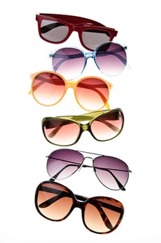Assorted styles of tinted sunglasses isolated on white background