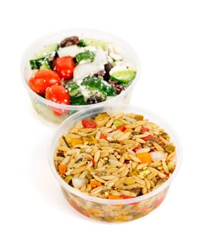 Two servings of prepared salad in plastic takeaway containers