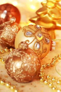 Still life with Christmas ornaments in golden tone