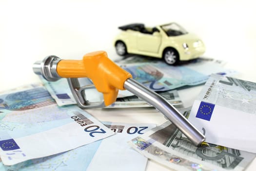 Fuel nozzle and euro bills against white background
