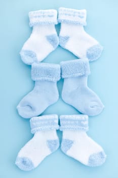 Arrangement of three pairs of blue infant boy socks for baby shower