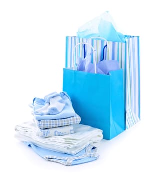 Gift bags and infant clothes for baby shower isolated on white