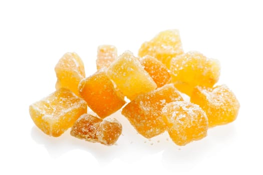 Caramelized ginger candy pieces isolated on white background
