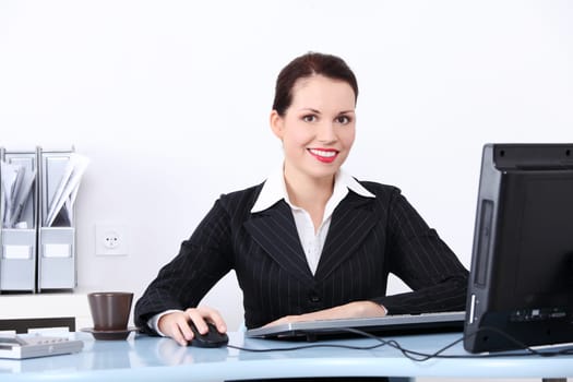 Pretty caucasian businesswoman sitting in the office.