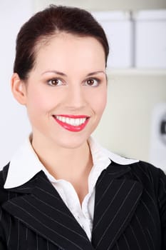Closeup on pretty caucasian smiling businesswoman`s face.