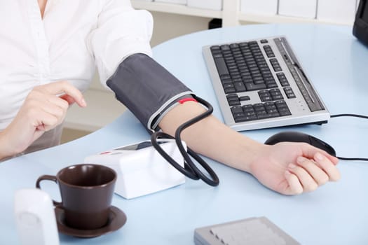 Woman`s hand with manometer.