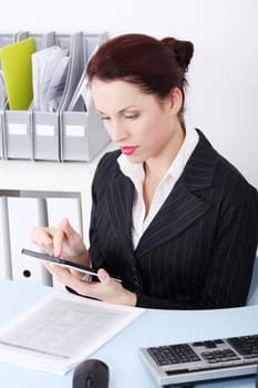 Pretty caucasian businesswoman using a tablet in the office.