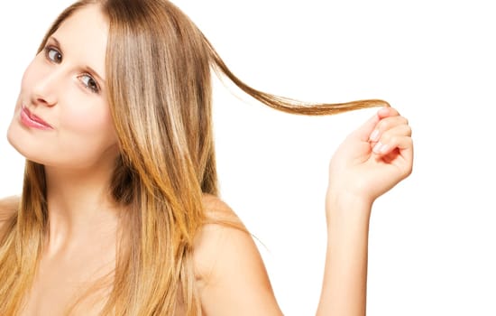 Young mischievous woman playing with her hair on white background