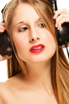 Young blonde woman with headphones listening to music