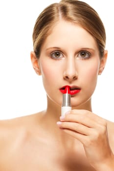 Young beautiful woman applying lipstick on against white background