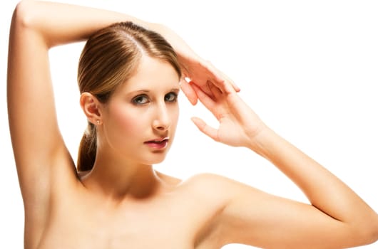 Young woman holding arms above her head on white background