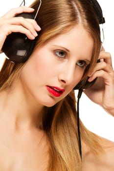 Young woman in headphones listening to music on white background
