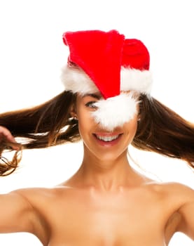 Young woman in Santa hat having fun on white background