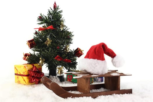 a sleigh with a Santa hat in the snow