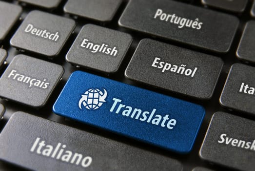 Multilingual translation online concept. Close up of multi language keyboard and translate word key in blue color with clippingpath.