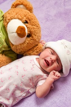 baby with her ​​teddy bear