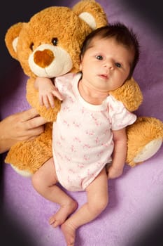 baby with her ​​teddy bear