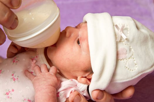 baby eating from a bottle