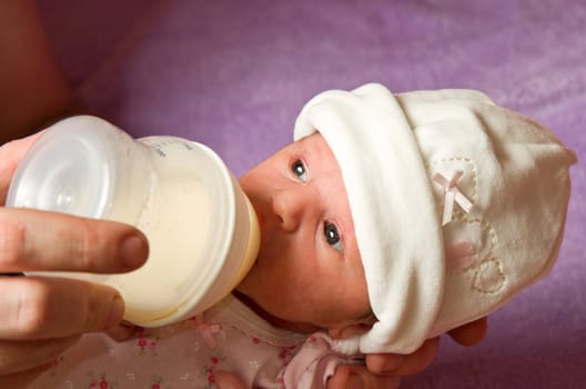 baby eating from a bottle