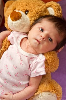 baby with her ​​teddy bear