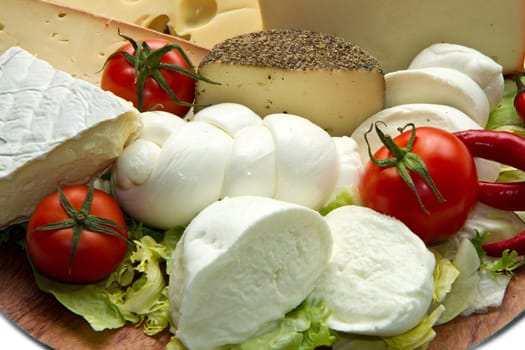 Various types of cheese on wooden board